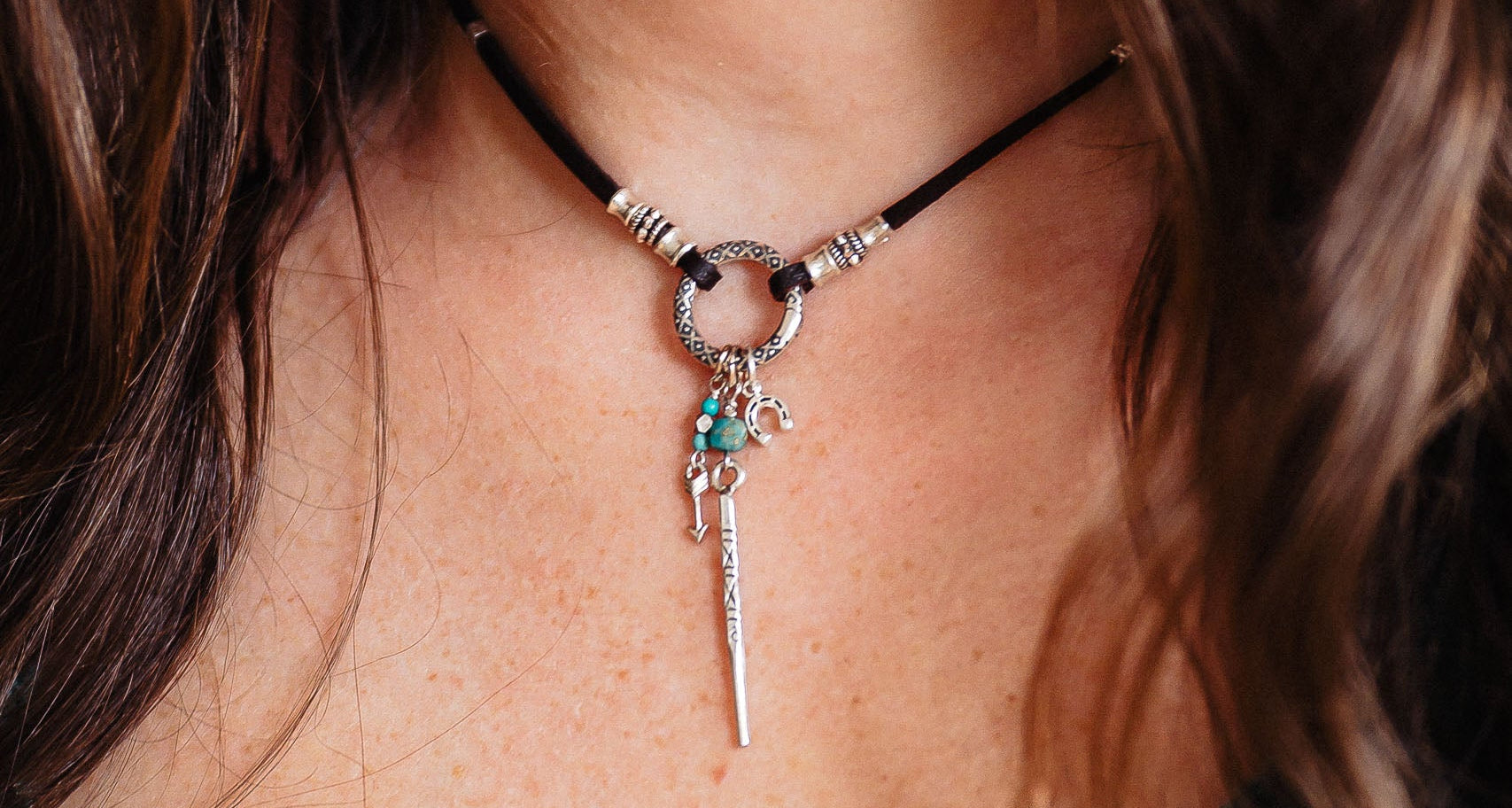 Necklace with a pendant worn by a person, close-up view.