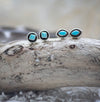 Southwestern silver and Turquoise stud earrings. This picture shows both available styles: circular silver with a diamond piece of turquoise displayed on a black background AND marquise shape silver with a marquise piece of Turqoise on a back background.  These studs are handmade authentic Native American jewelry. 